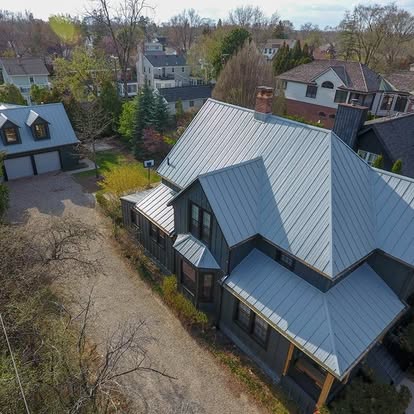 A large house with many different types of roofs.