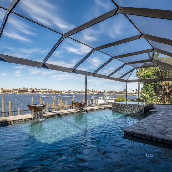 A pool with an ocean view and a deck.