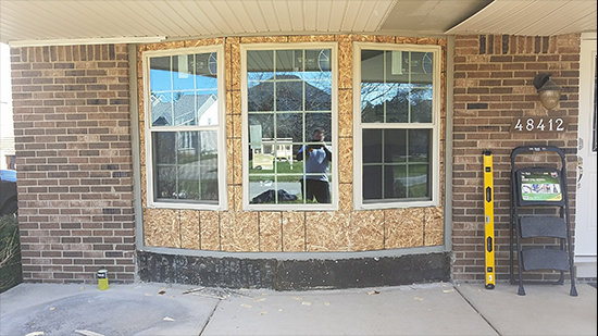 A man standing in front of a window.