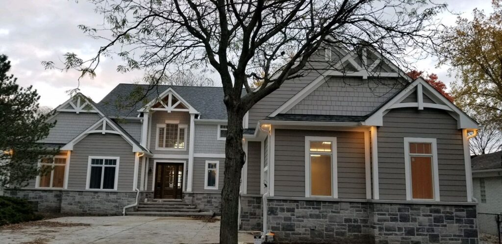 A large house with a tree in front of it.