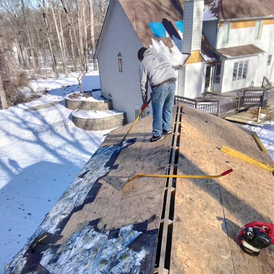 A man standing on the roof of a house