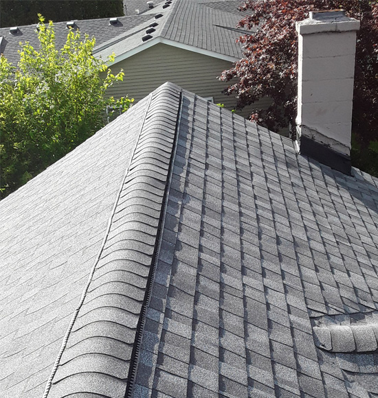 A roof with multiple different types of shingles.