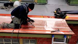 A man working on the roof of a house.