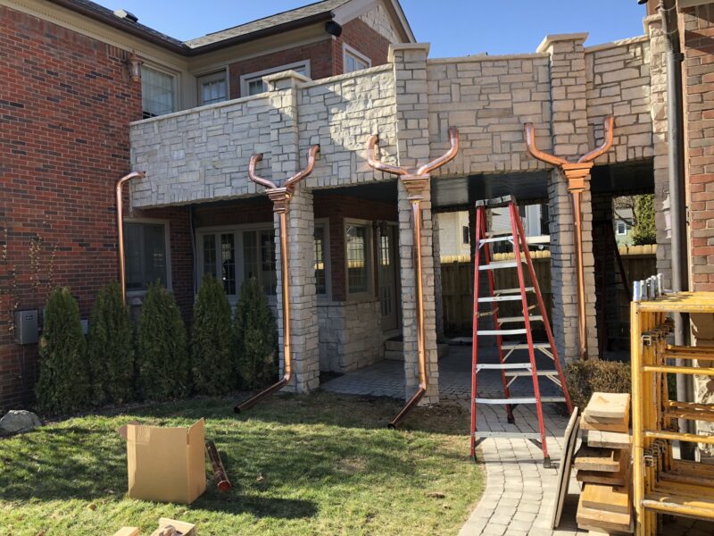 3G Home Exteriors team completing copper gutter installation work in Northville MI