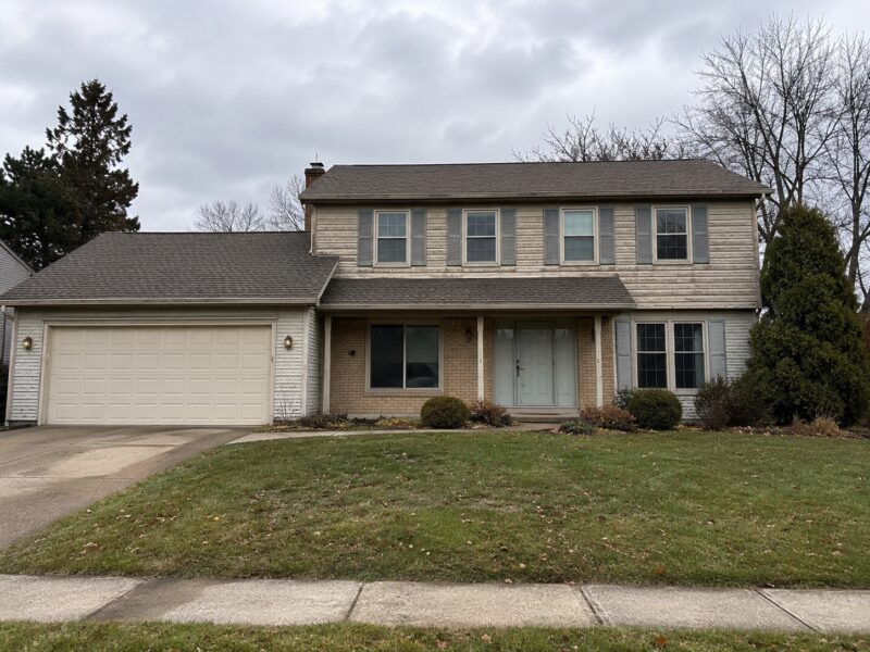 Faded home exterior before repainting and trim refresh in Metro Detroit
