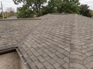 After storm damage roofing work showing restored asphalt shingle coverage