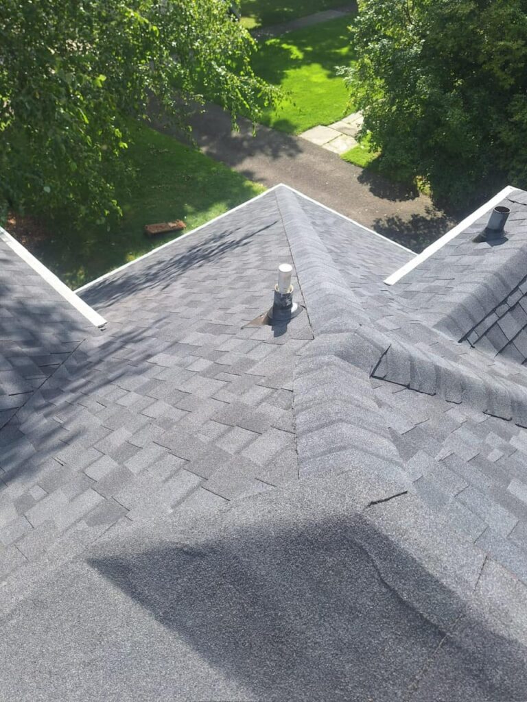 Aging brown shingle roof aerial inspection