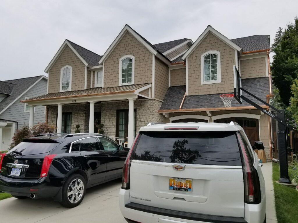 Front view of a residential home with newly installed copper gutters