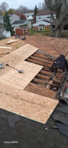 Roof deck repair in progress during a residential roof replacement
