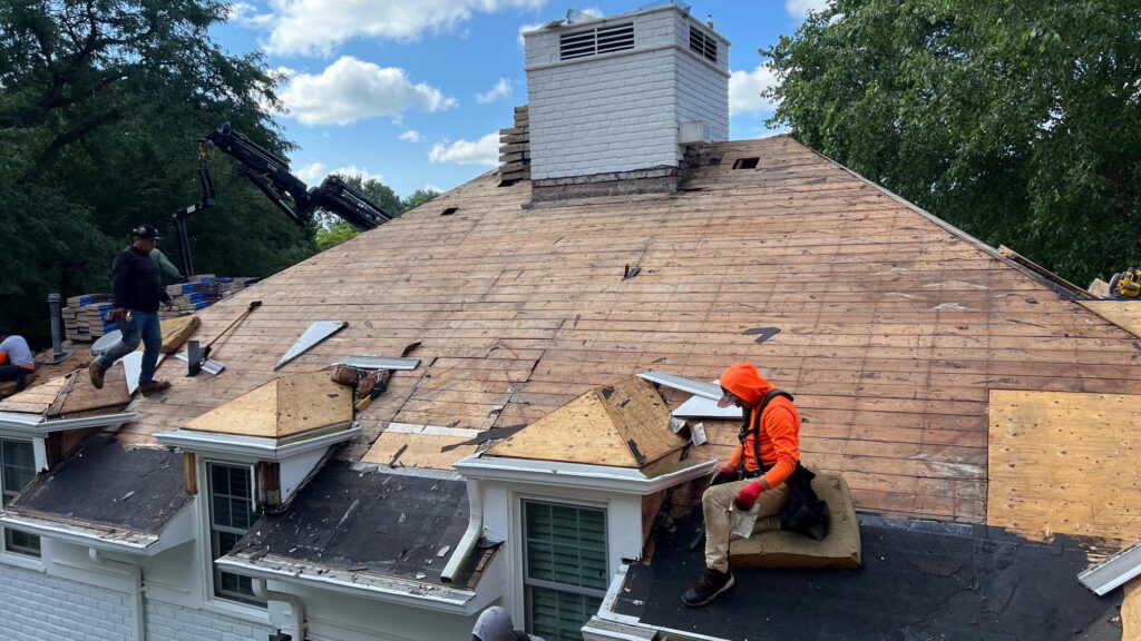 Roofing crew installing new roof deck
