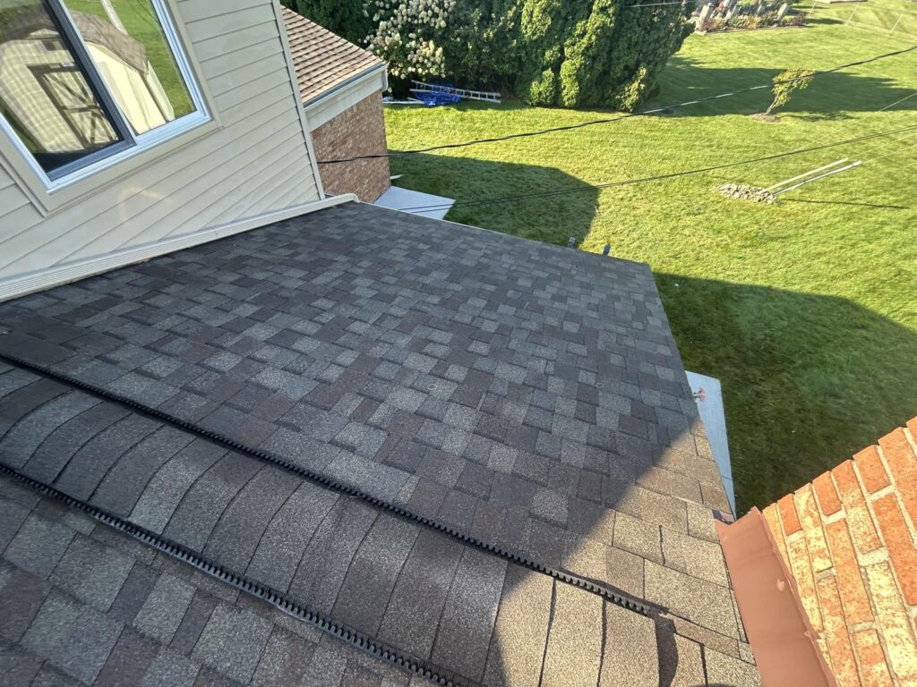 Worn asphalt shingles before roof repair