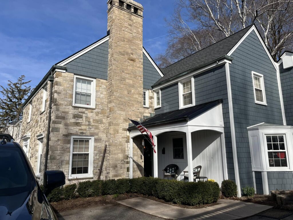 Blue james hardie siding on stone home
